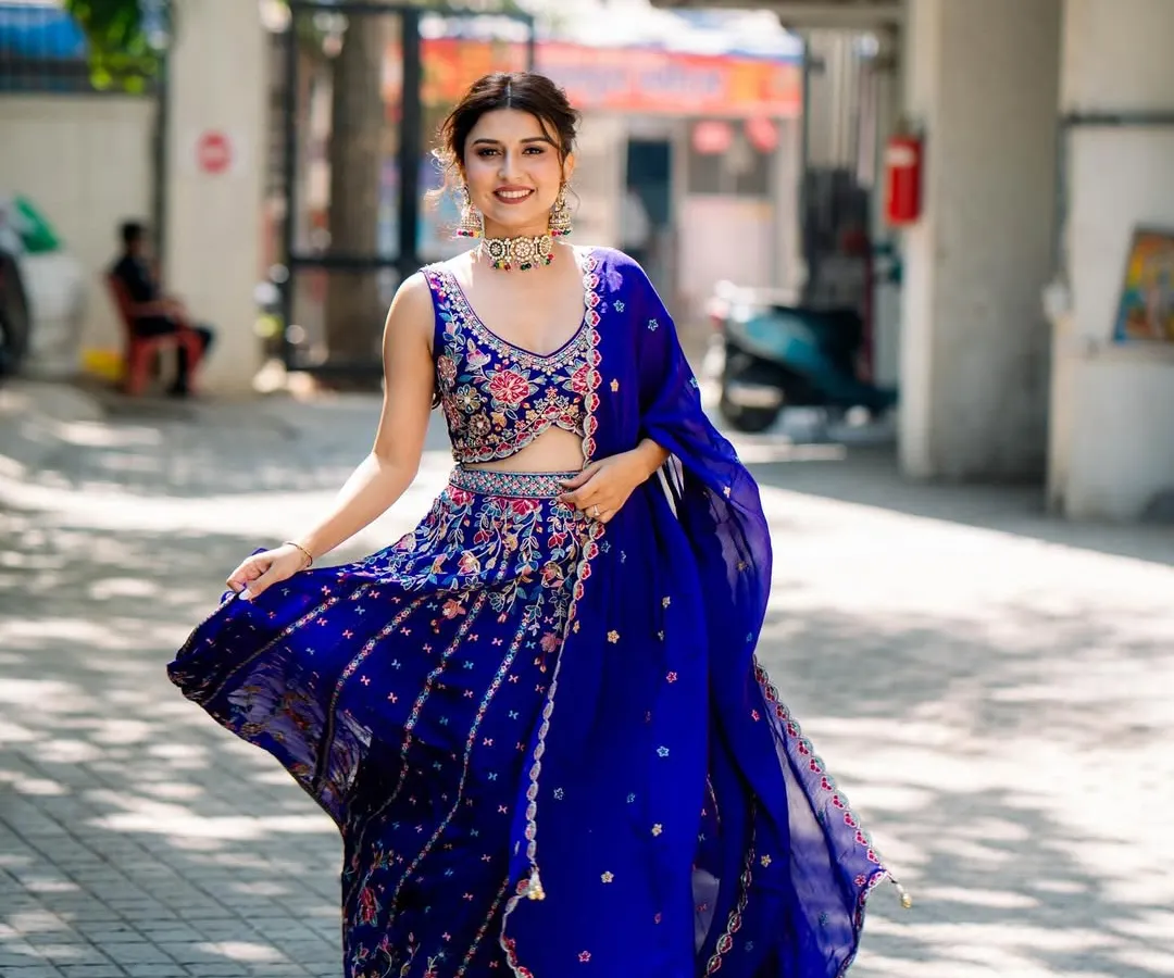 Our client looks absolutely radiant for her mehendi ceremony in this vibrant royal blue lehenga. The intricate floral embroidery and flowing dupatta create a perfect look for a joyful celebration. We help you find pieces that match the energy of your event.