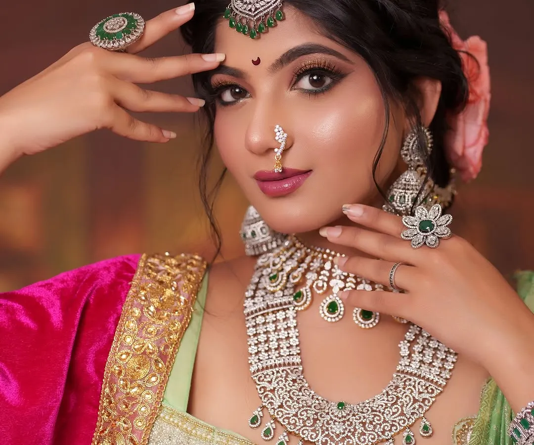 Embodying the spirit of a regal Maharashtrian queen. This look features intricate diamond and emerald jewelry, including a statement necklace and maang tikka, perfectly complementing the rich Peshwai-style attire for a powerful character portrayal.