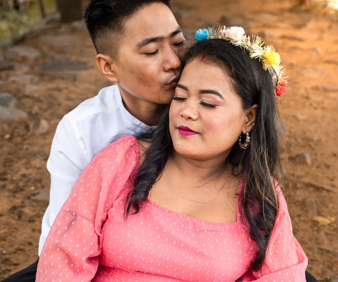 A quiet moment of love and anticipation. During this outdoor maternity photoshoot, I focused on the tender connection between the parents to be, with a gentle kiss and a loving embrace. The warm, natural light perfectly highlights the glow of impending parenthood.