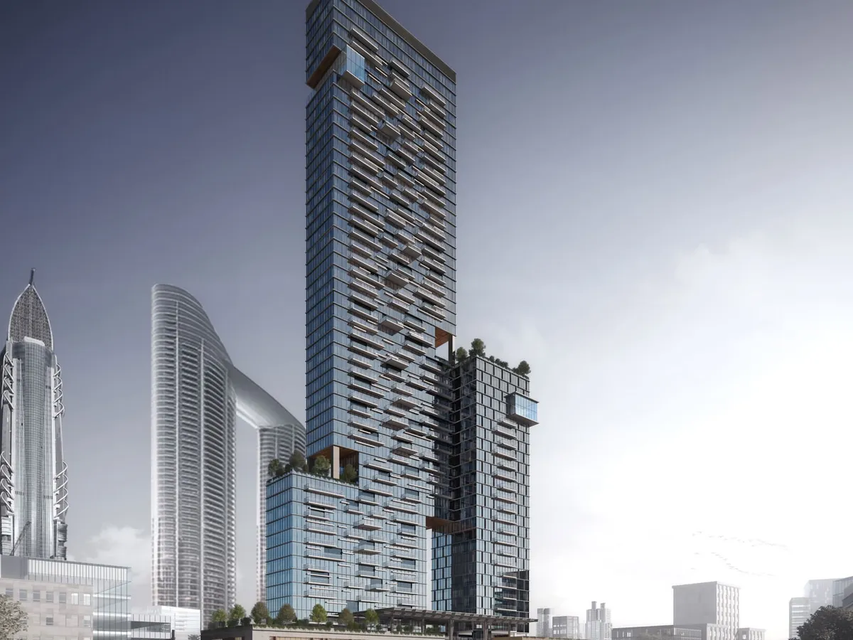 A photorealistic 3D exterior render of a skyscraper concept in Dubai. This daytime view highlights the building's complex glass facade and its integration into the existing urban skyline, demonstrating our ability to handle large scale architectural projects with precision.