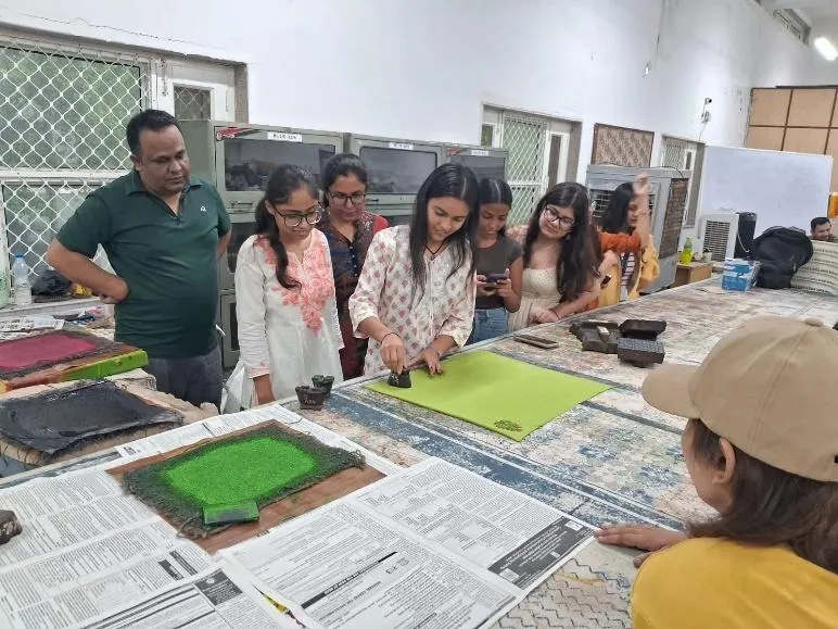 We believe in learning by doing. Here, one of our fashion students gets hands-on experience with traditional block printing techniques during an industrial visit, connecting classroom theory with real-world craft.