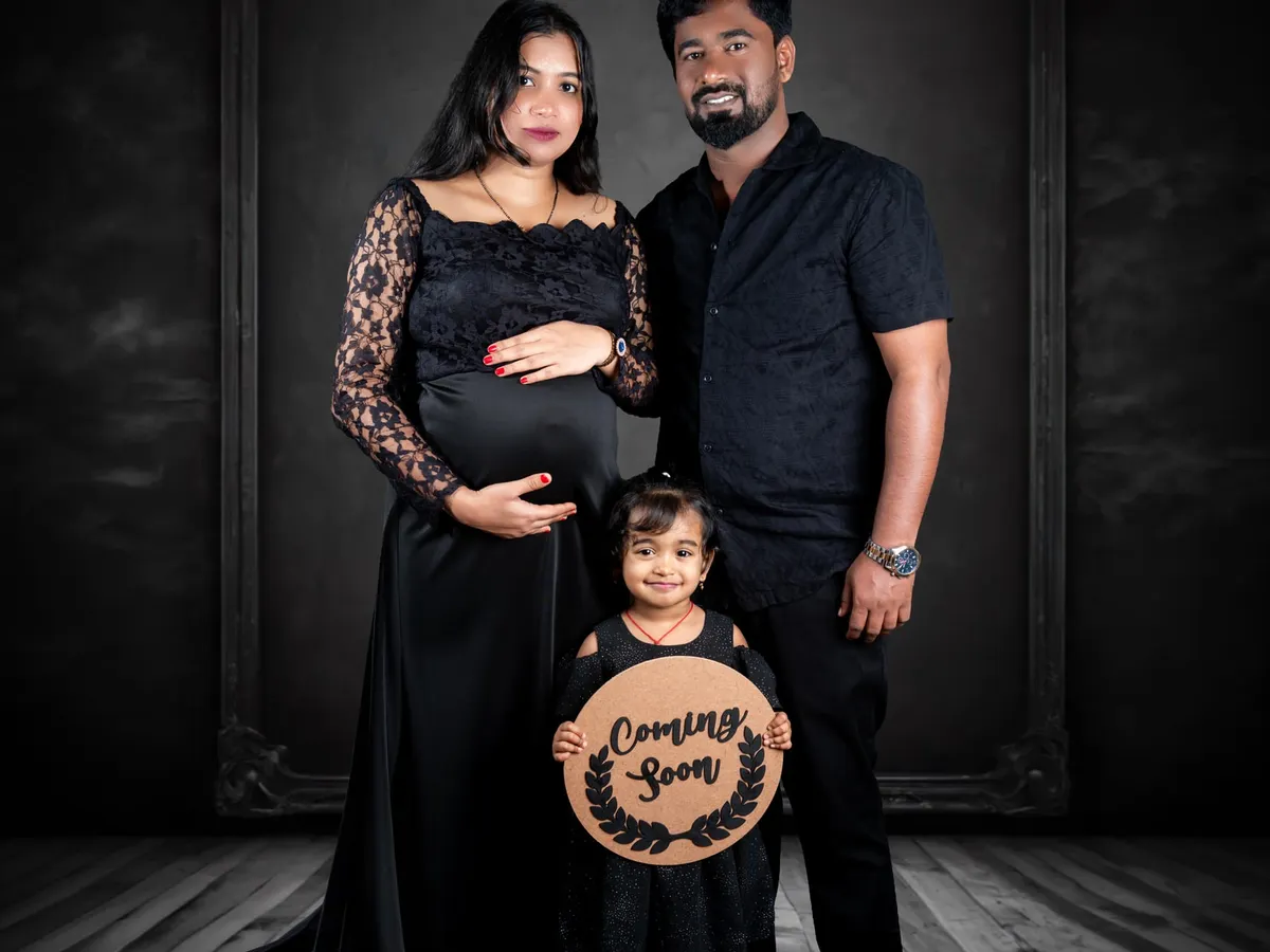 A dramatic and elegant maternity portrait from our studio. We work with expecting parents to create powerful images that celebrate this special time, offering styling assistance and a range of gowns to achieve the perfect look.