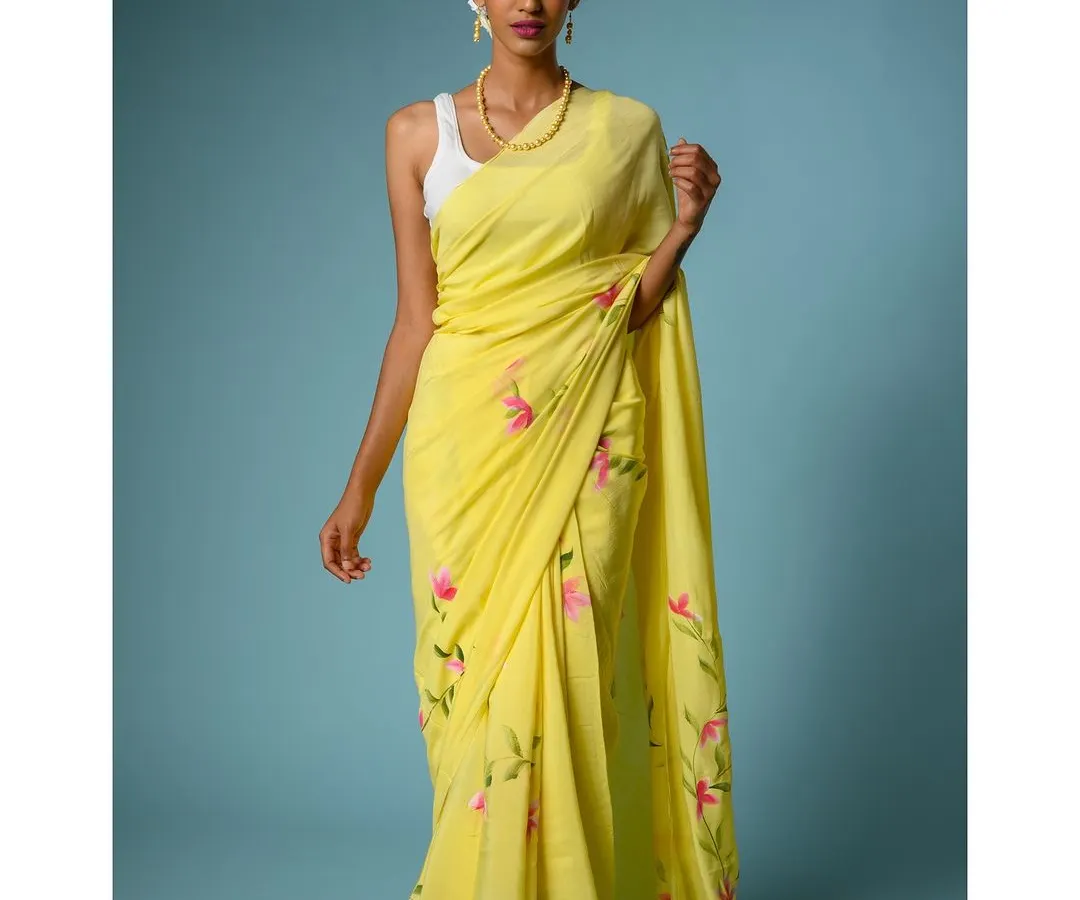 For e-commerce brands, a clean, vibrant, and perfectly lit image is everything. Here, I've used a solid color background to make this beautiful yellow hand-painted saree pop, highlighting the intricate details and true-to-life colors for online shoppers.