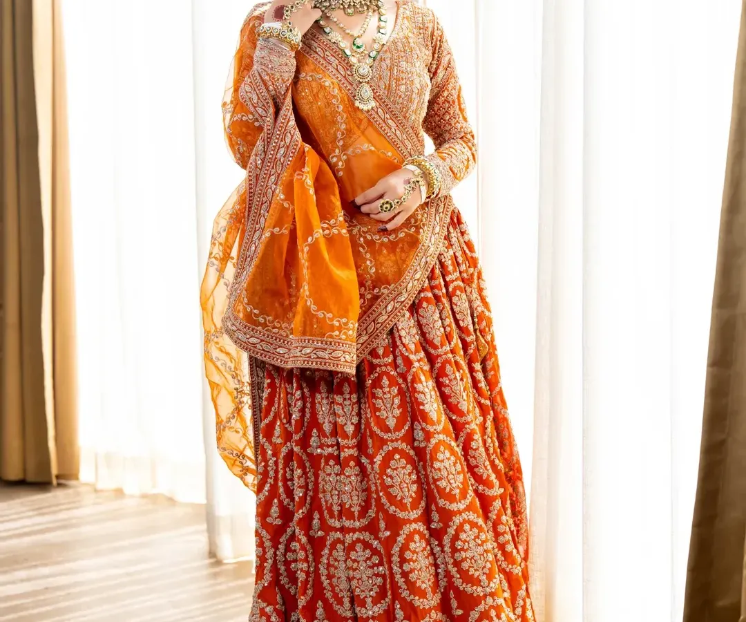 For the bride who wants to look nothing less than royal. This burnt orange lehenga with its rich embroidery and sequin work is a true masterpiece. We make sure every detail is perfect, so you can shine on your wedding day.