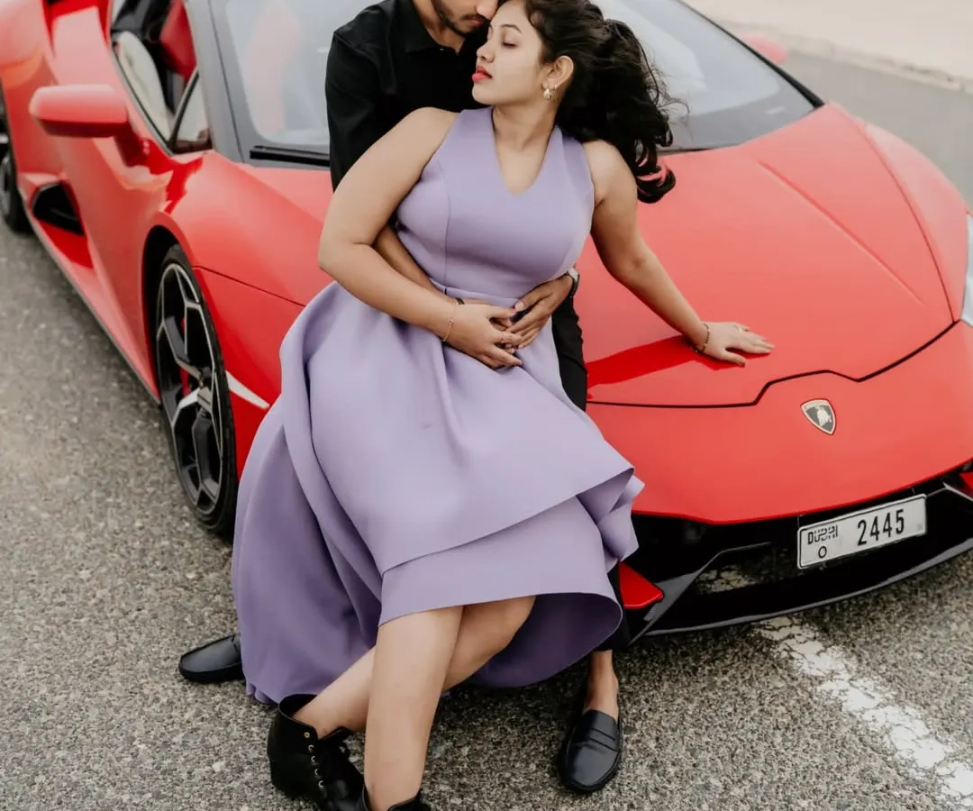 For the adventurous couple, a pre-wedding shoot in Dubai is an unforgettable experience. This shot with a vibrant red Lamborghini against the desert highway captures a story of modern luxury and romance.