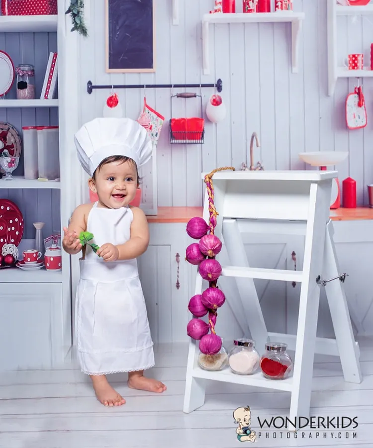 Capturing the pure joy of a toddler in our "Little Chef" themed photoshoot. Dressed in a chef's hat and apron, this little one's smile is the main ingredient for a perfect picture.