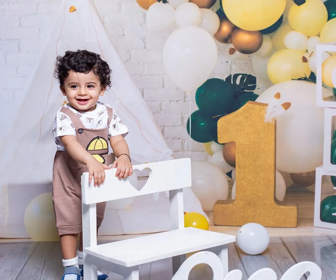 Celebrating a first birthday is a huge milestone. I provide a full setup with props like this large number 'one' and a beautiful balloon arch, so you can focus on enjoying your baby's special day while I capture their happy smiles.