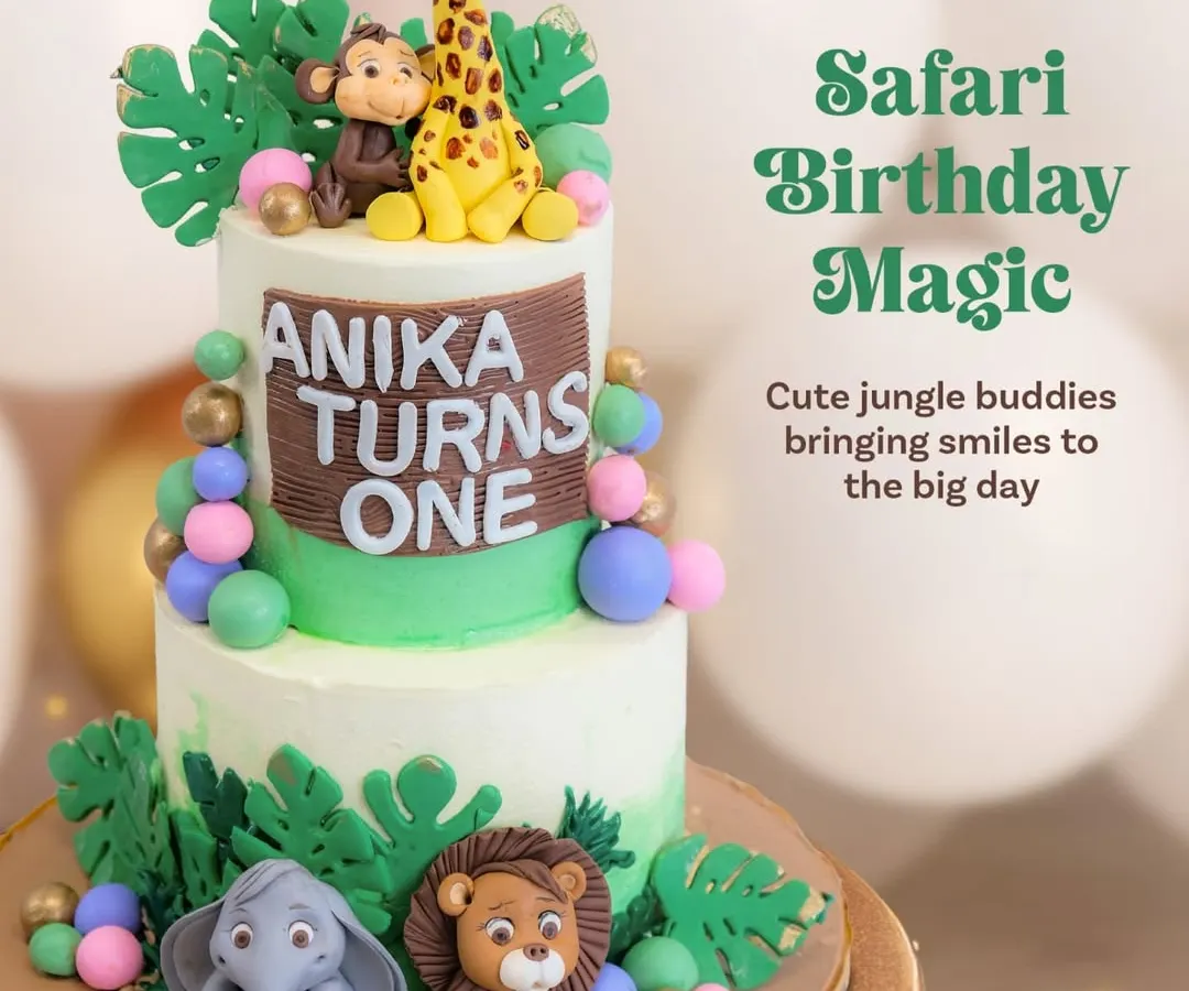 For little Anika's first birthday, we created a two-tier safari adventure. This cake features a whole family of adorable, hand-sculpted fondant animals like a giraffe, monkey, lion, and elephant, bringing the jungle theme to life.