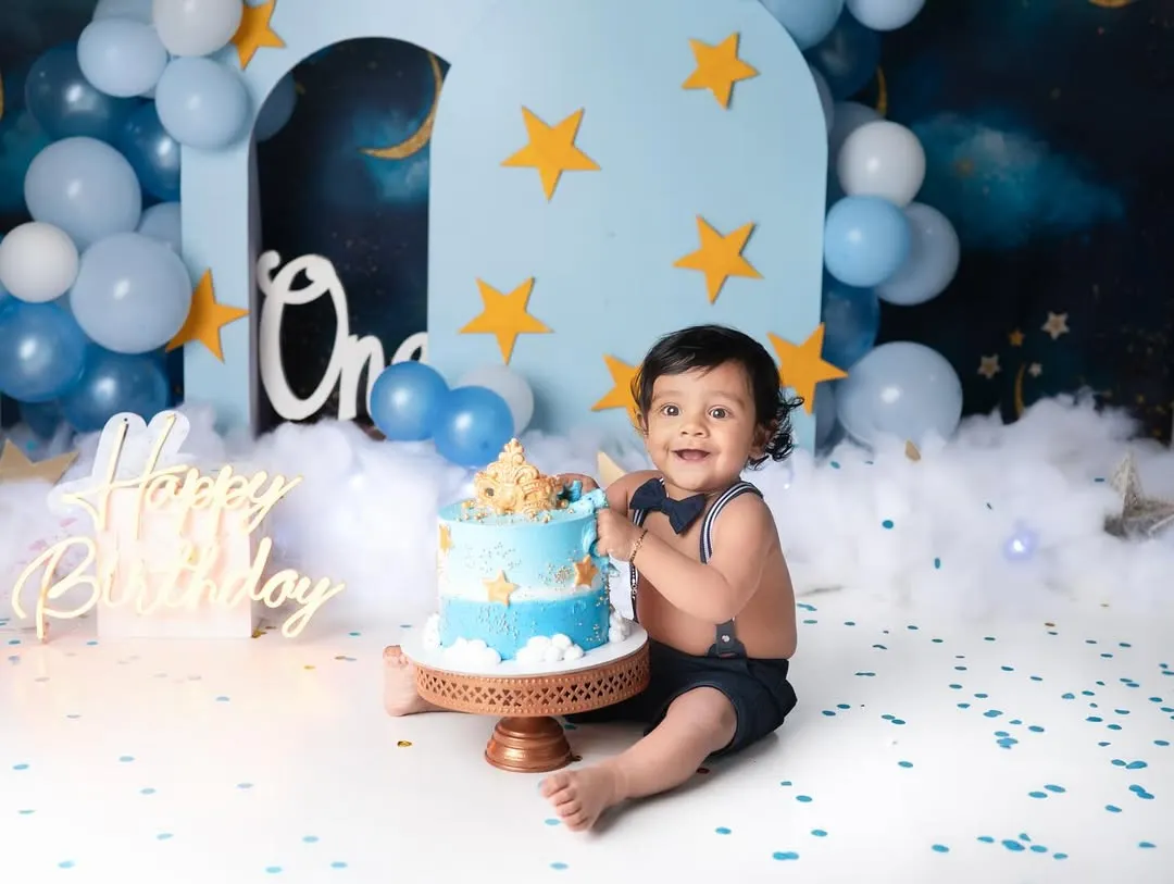 Nothing says "Happy First Birthday" like a cake smash! This little guy had the best time with his starry night themed celebration, and his joyful smile says it all.