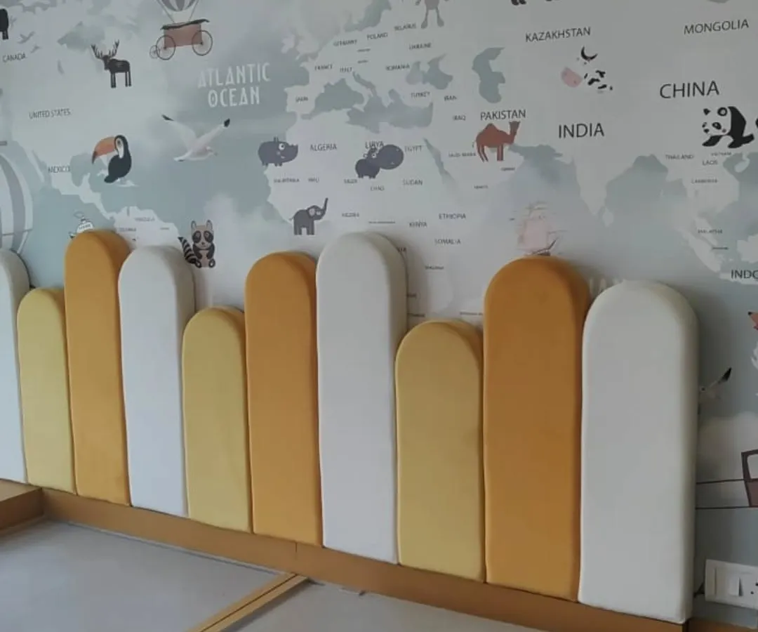 We can bring any theme to life, like this world map wallpaper for a child's room. Paired with a custom-cushioned headboard, it creates a fun and educational space. This is a great example of an accent wall that transforms a room's entire feel.
