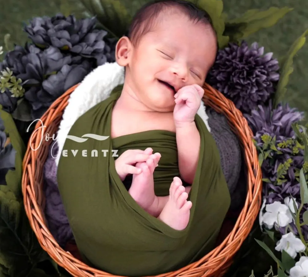 The pure bliss of a newborn's smile is a moment to cherish forever. We specialize in newborn photography in Bangalore, ensuring a safe and comfortable session where your baby is gently swaddled and posed in our cozy, floral-themed props.