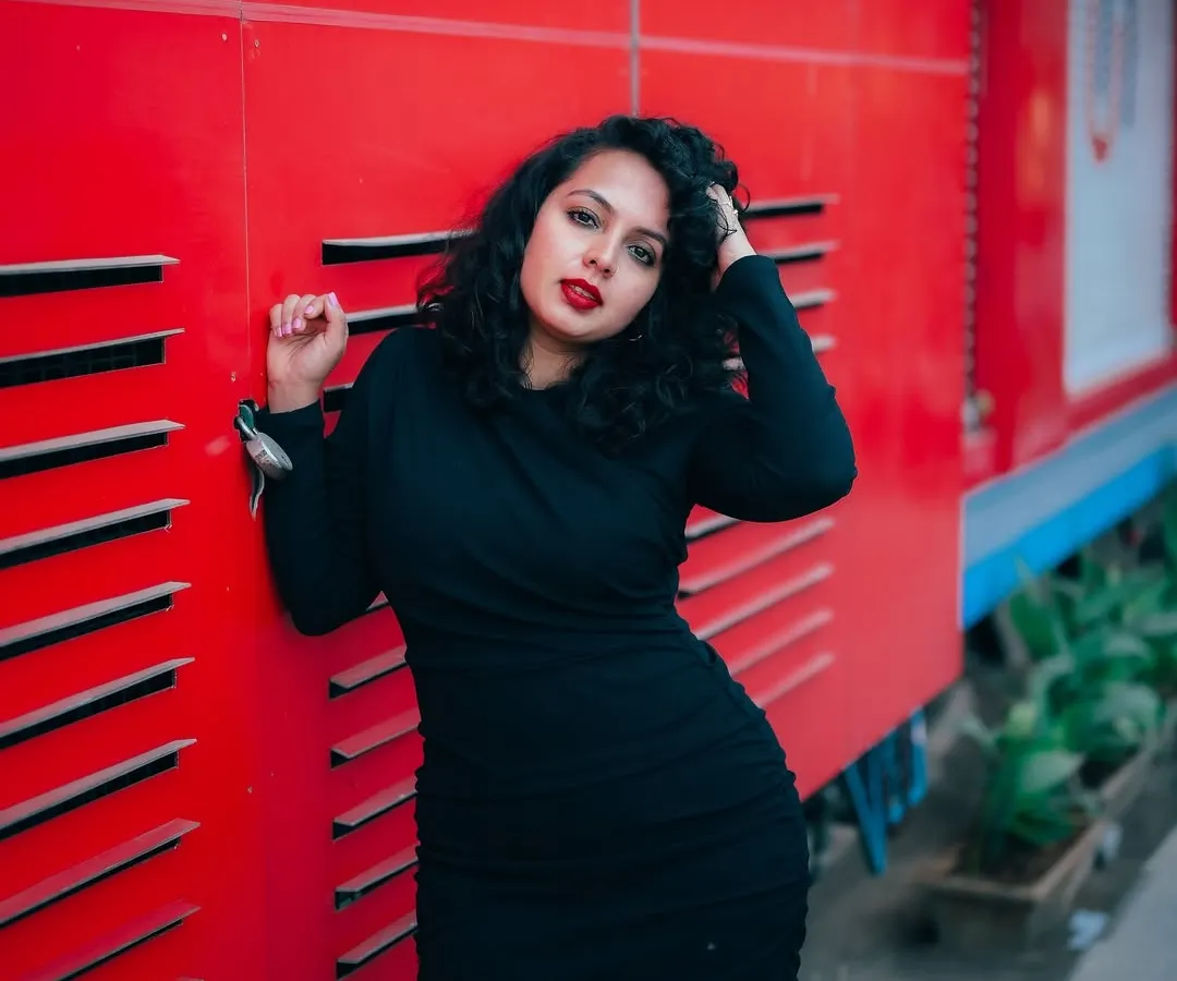 I use bold colors and strong compositions to make fashion portraits pop. This shot against a vivid red wall in Bangalore shows how an urban environment can become a dynamic studio for creating high-impact images.