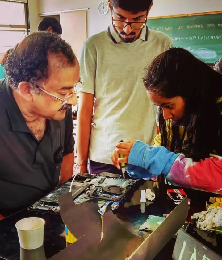 Don't be intimidated by complex electronics. At our sessions, we create a supportive space where you can learn to diagnose and repair gadgets like laptops. A volunteer mentor is guiding a participant through the process, step by step.