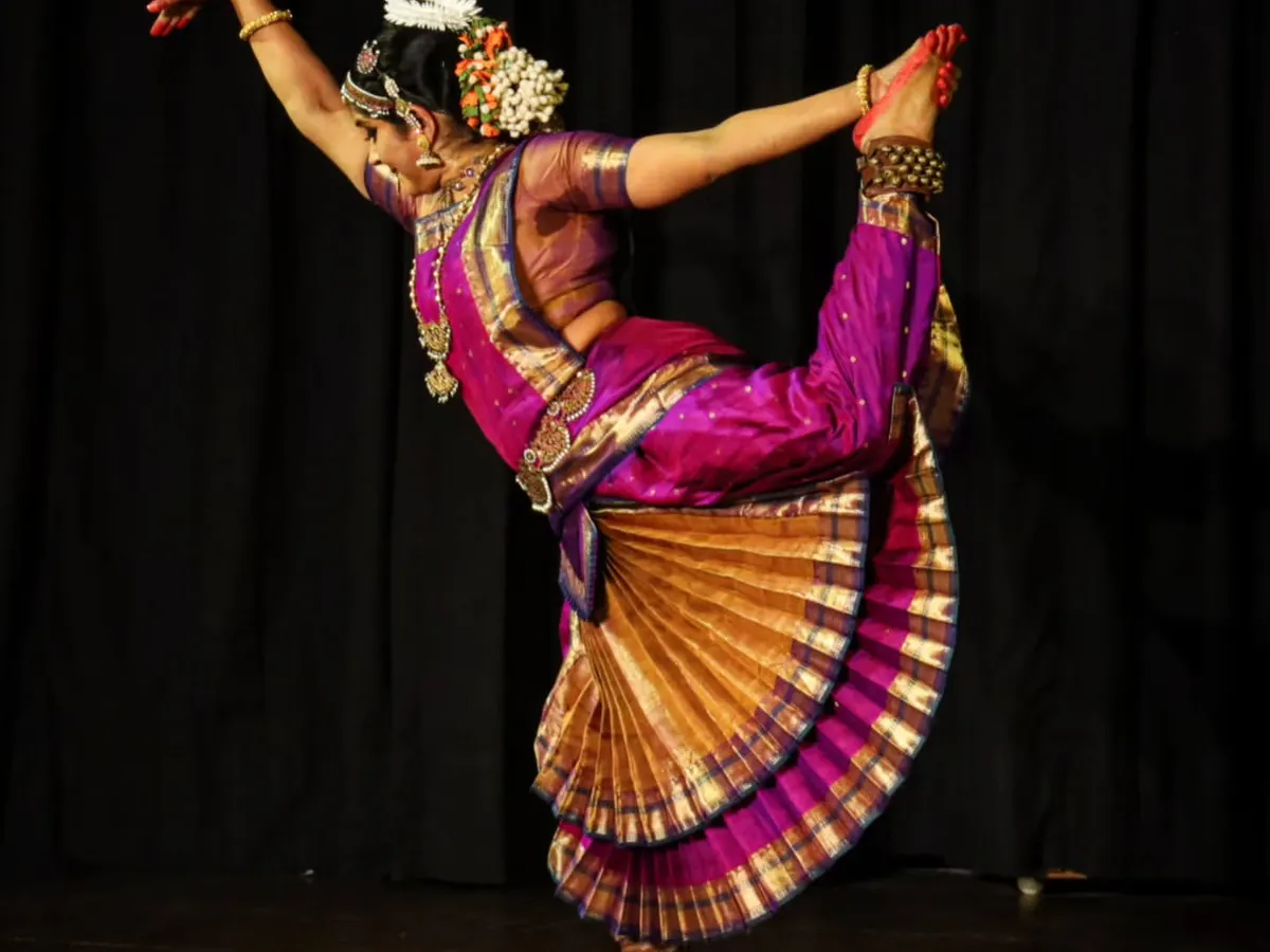 A moment of dynamic energy from my solo production, "Moham". This pose captures the physical discipline and grace that Bharatanatyam demands, showcasing the culmination of years of training in a single, powerful movement on stage.