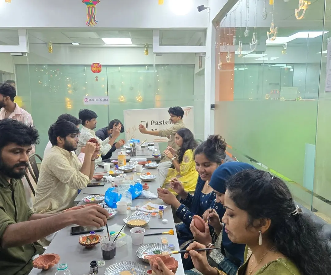 I can bring the entire pottery workshop right to your office. Here’s a look at a full team engaged in a festive diya painting session, a perfect way to celebrate together.
