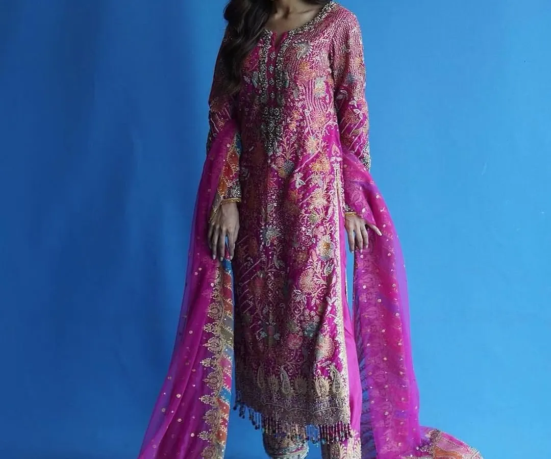 For me, this is Punjab di shaan. I styled this vibrant pink Punjabi suit to highlight the intricate, traditional embroidery while ensuring the fit and drape felt modern and powerful. The bold blue background makes the colors pop, perfect for a memorable photoshoot.