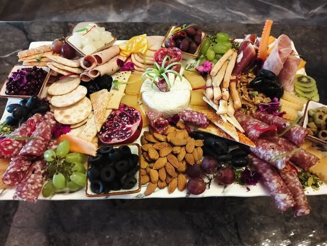 A feast for the eyes and the palate. Our abundant charcuterie boards are thoughtfully arranged with a premium selection of cured meats, artisanal cheeses, fresh fruits, and crisp crackers for a perfect grazing experience.