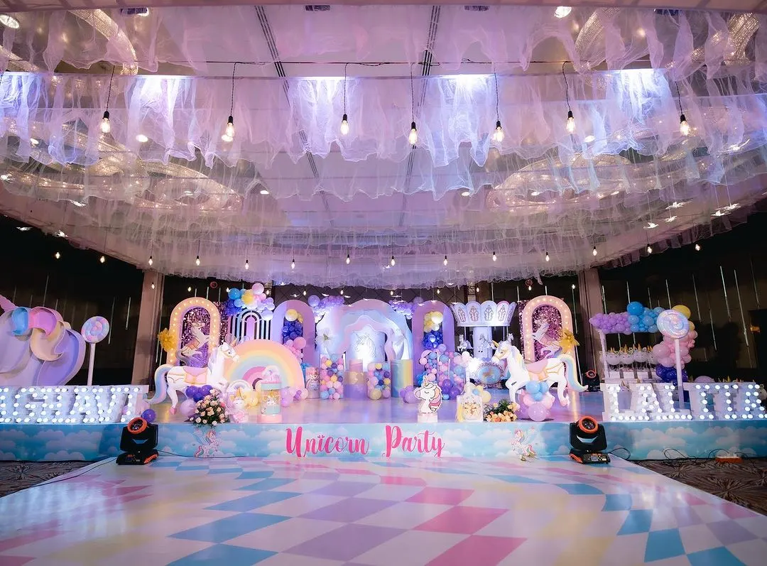 This is what a child's dream looks like. I designed this grand unicorn theme birthday party, focusing on a pastel wonderland with a custom stage, themed dance floor, and a magical ceiling treatment to transport all the guests.