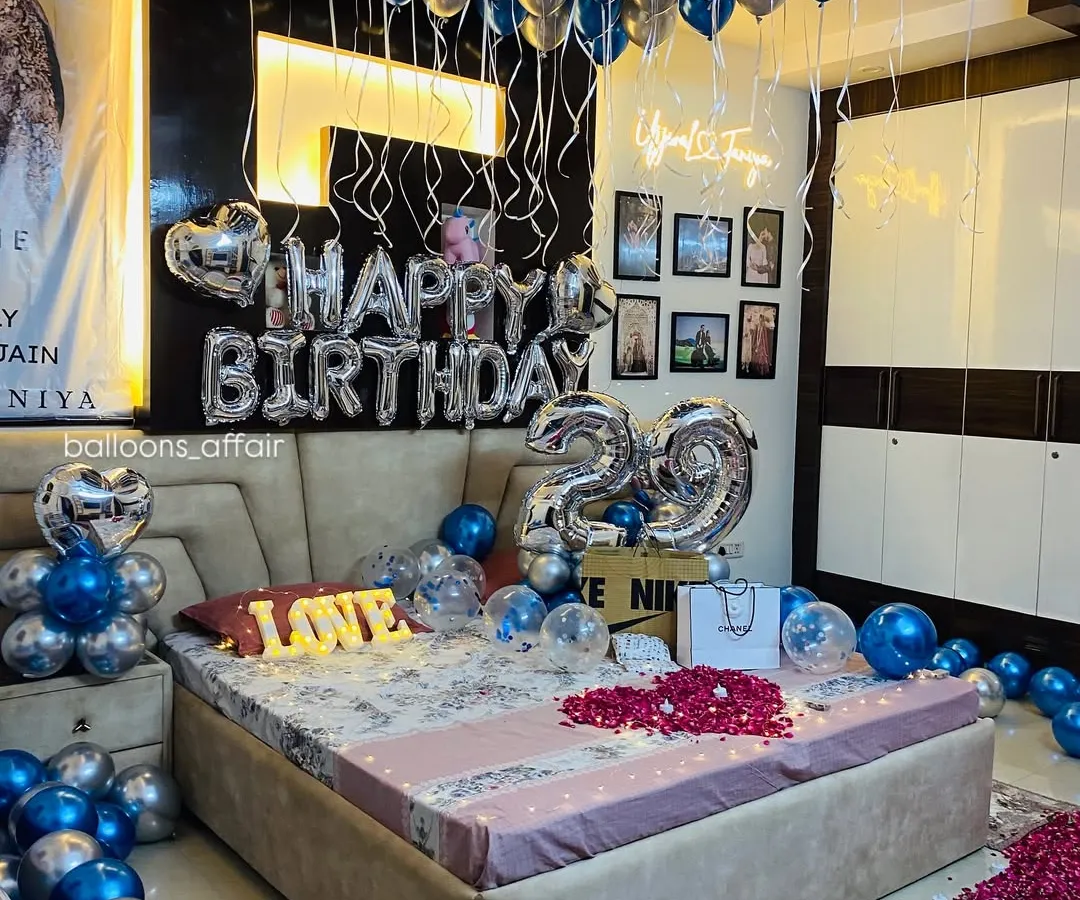 This is one of my most requested birthday decoration packages. The room is filled with metallic blue and silver helium balloons, with large foil balloons for the age and a "Happy Birthday" message, creating a full and festive atmosphere.