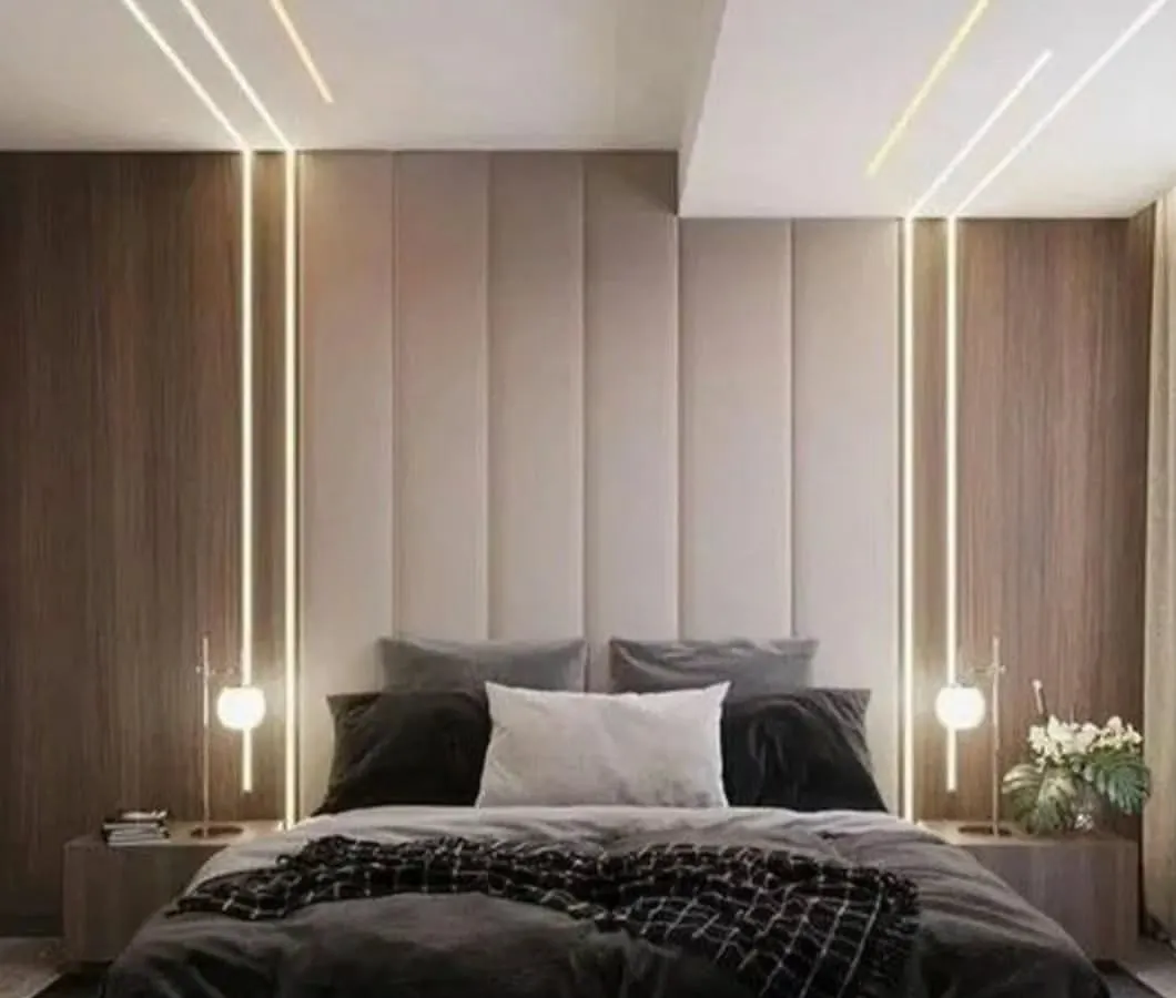 I create serene and luxurious master bedrooms that feel like a personal retreat. This design uses a combination of vertical wood paneling, a plush upholstered headboard, and layered ambient lighting to build a warm and inviting atmosphere.