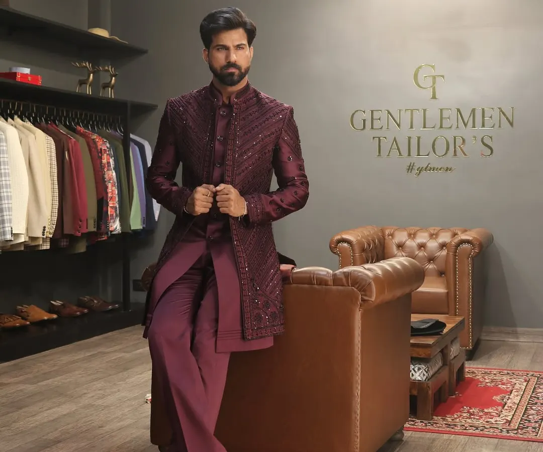 This wine-colored Indo-western ensemble, featuring a sequined long jacket over a matching kurta and trousers, exemplifies our approach to modern celebratory wear. Photographed in our studio, it showcases the sharp tailoring and luxurious feel of our creations.