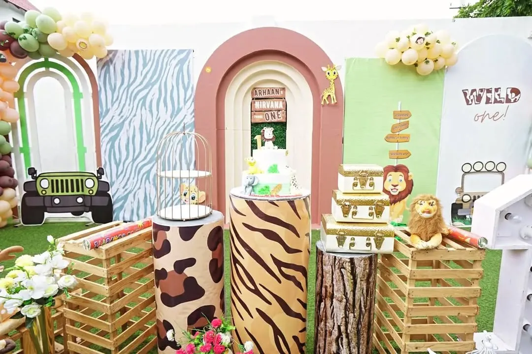 I love how this 'Wild One' safari theme came together for a first birthday. We used multiple themed backdrops, animal print plinths, and fun props like the jeep cutout to create a truly immersive jungle experience for the little one and the guests.