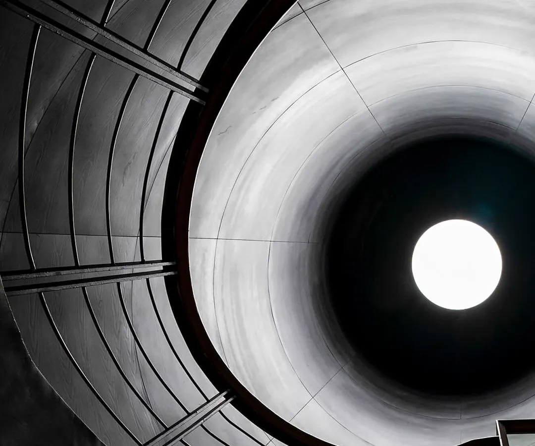 For the BCG Headquarters in Mumbai, we reimagined the corporate environment. This view looks up through a 'skylit' circular courtyard, a core element that brings light and air deep into the vertical campus, echoing the industrial past of the city.