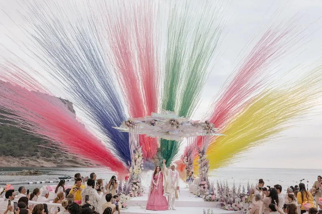 A spectacular moment of celebration as Roopali and Milap complete their pheras. The explosion of color against the serene beach backdrop in Ibiza captures the sheer joy and grandeur of a destination wedding, a story we love to tell through our lenses.