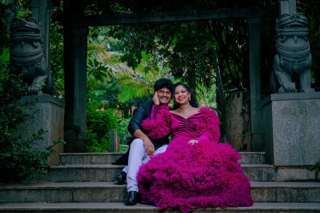A dramatic and romantic portrait of an expecting couple. I use architectural elements and natural surroundings in Bangalore's parks to frame your story, creating timeless images that feel both grand and intimate.