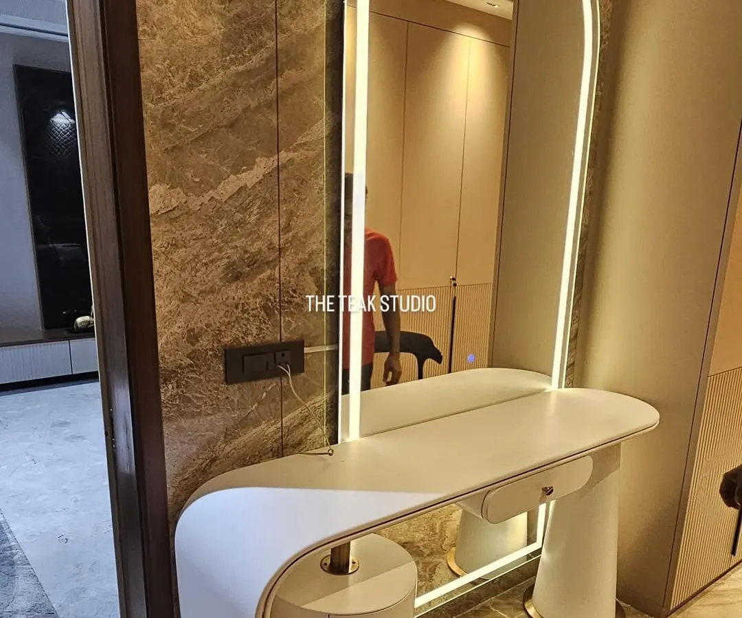 A perfect example of functional luxury. We crafted this elegant vanity table for a client's personal dressing space, featuring a sleek curved design, integrated drawers, and a beautiful arched mirror with built-in ambient lighting.