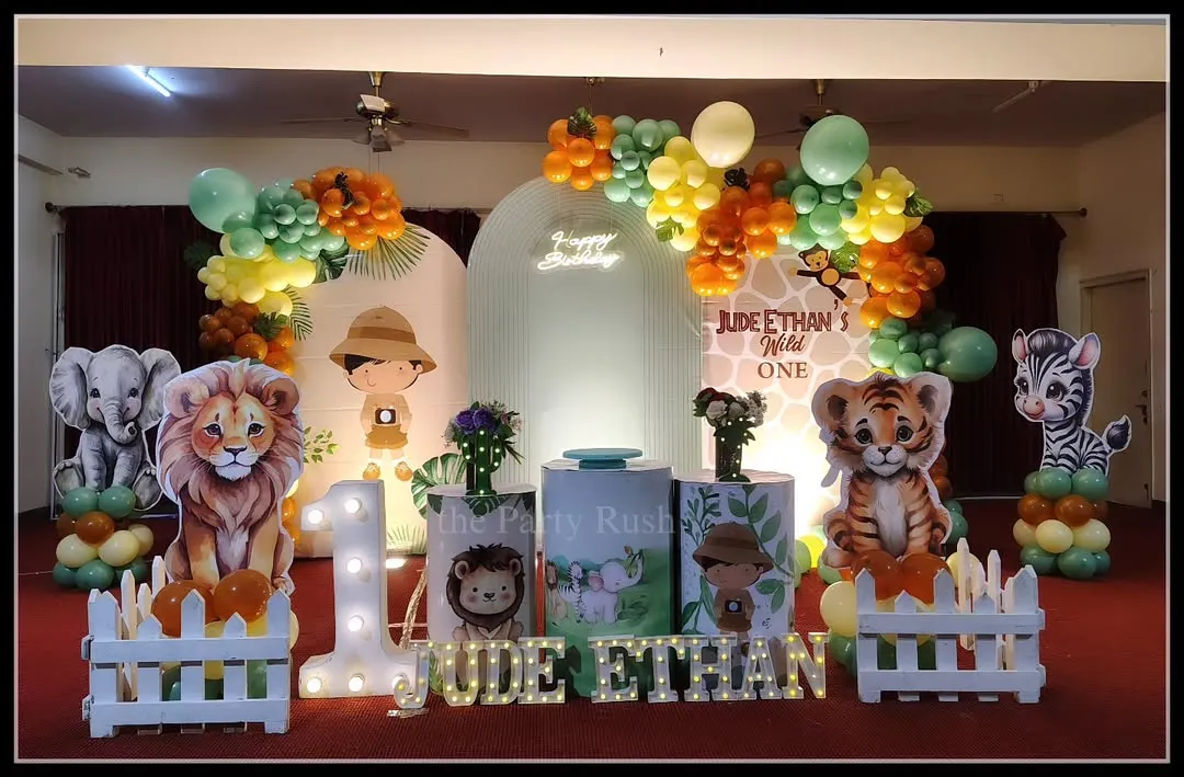 For Jude Ethan's 'Wild One' party, I created a friendly and inviting jungle scene. This setup includes adorable, life-sized cutouts of a lion, tiger, elephant, and zebra, a large light-up number '1', and marquee letters for the name, all set against a custom backdrop and framed by organic balloon arrangements.