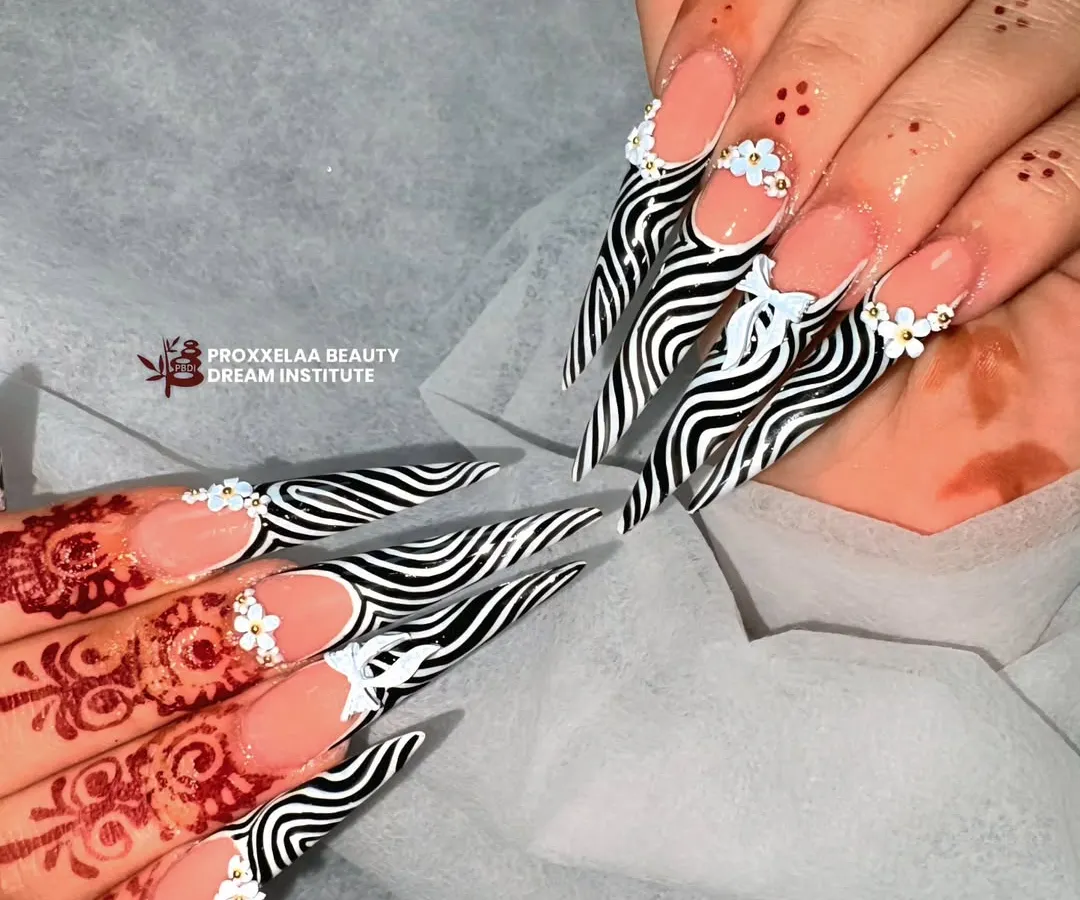 For a look that's fierce and fabulous, I hand-painted this high-contrast zebra print on dramatic stiletto extensions. The clean lines and sharp shape make a bold statement.