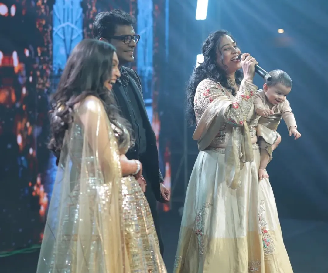 Here I am, a proud working mom, hosting a large sangeet ceremony with my daughter Gauri in one arm and the microphone in the other. This moment captures my core belief: women can balance their professional passions and motherhood. I help brands connect with this empowered audience.