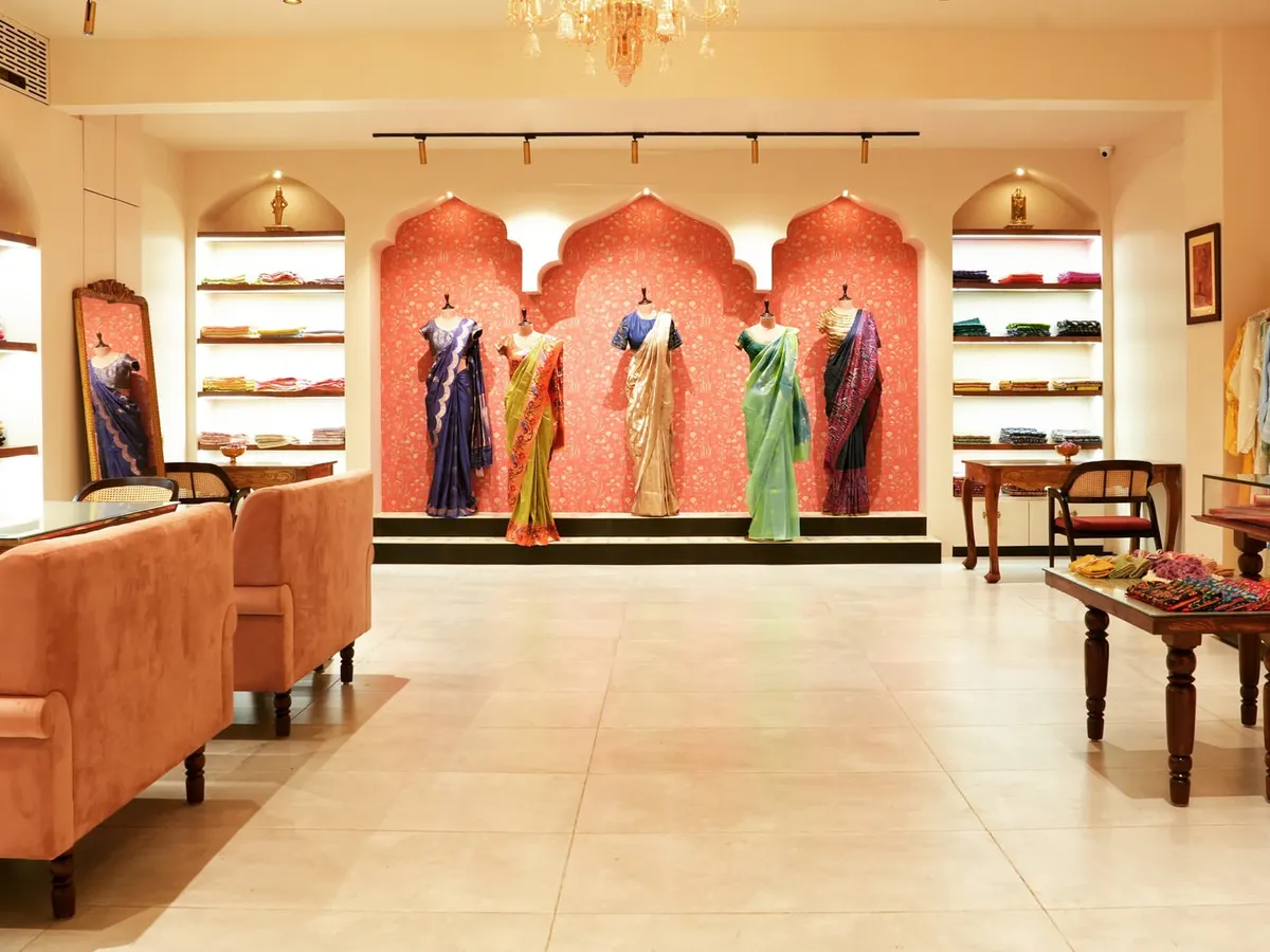 This wide view of the 'House of Vaarasa' boutique showcases our approach to retail design. We created an inviting, luxurious atmosphere with soft lighting, plush seating, and elegant archways that draw customers in and highlight the beauty of the handloom sarees on display.