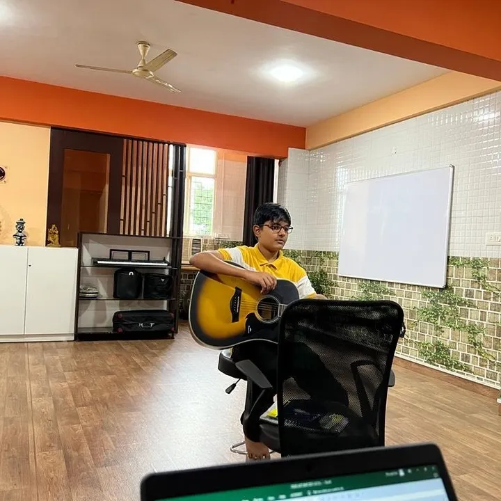 A young student focuses on his acoustic guitar during a lesson at our Bangalore studio. We provide one on one attention to ensure every student builds a strong technical and theoretical foundation.