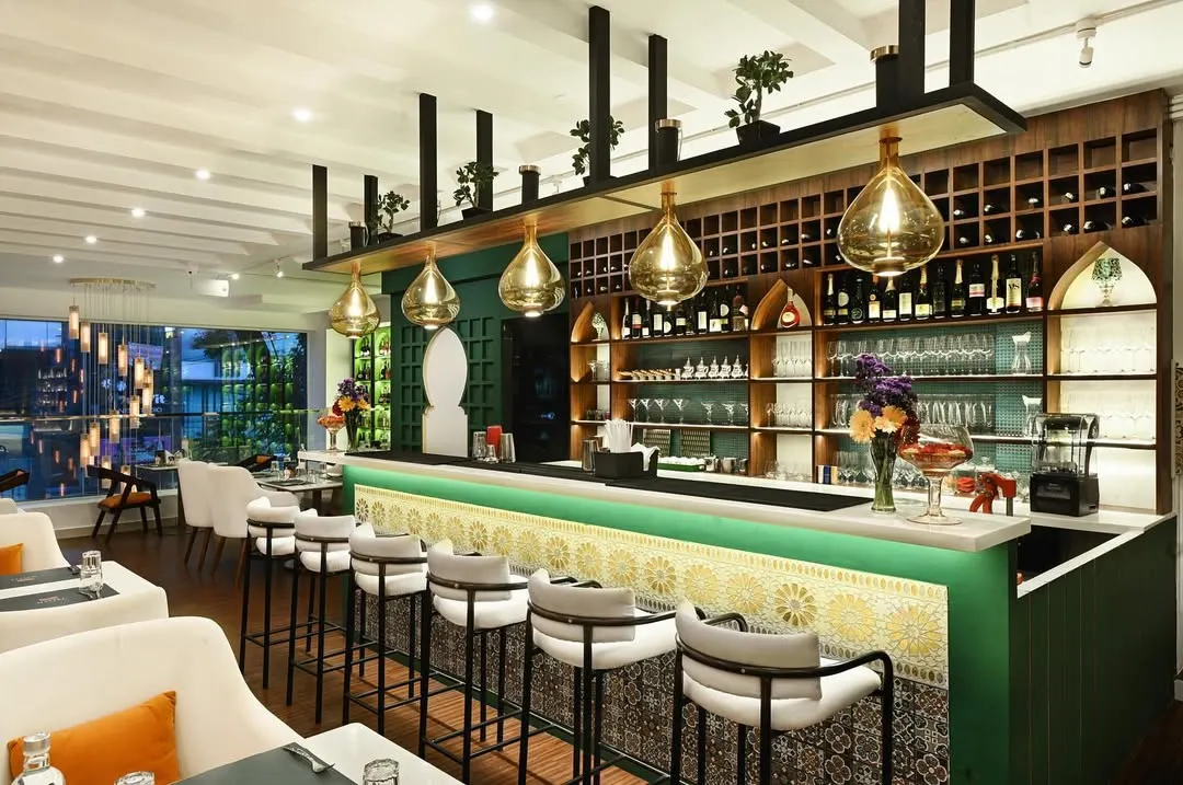 Our bar is the heart of the restaurant, a place for celebration and connection. The design features intricate tilework and warm lighting, with a fully stocked selection of world-class wines and spirits, creating the perfect backdrop for your private event or an evening of fine dining.