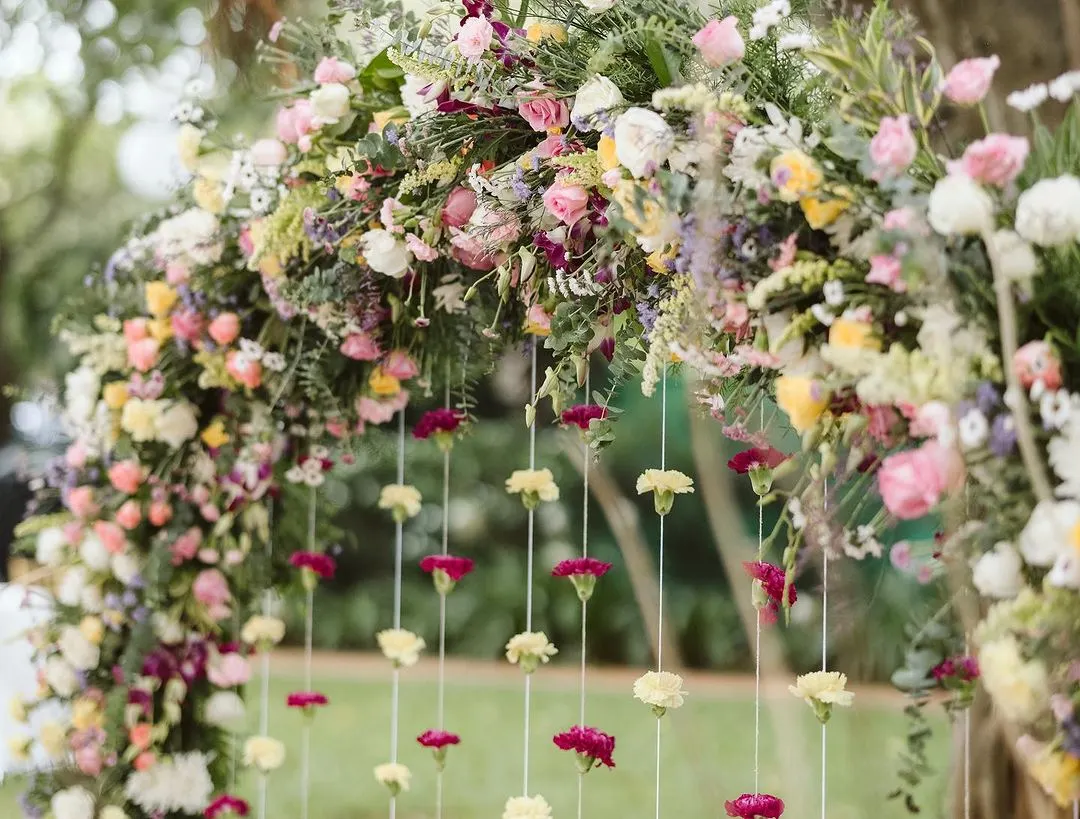 There's nothing more beautiful than a lush floral arch. For this Haldi ceremony, I designed a full, vibrant arch with hanging carnations that perfectly framed the couple and blended with the natural beauty of the garden.