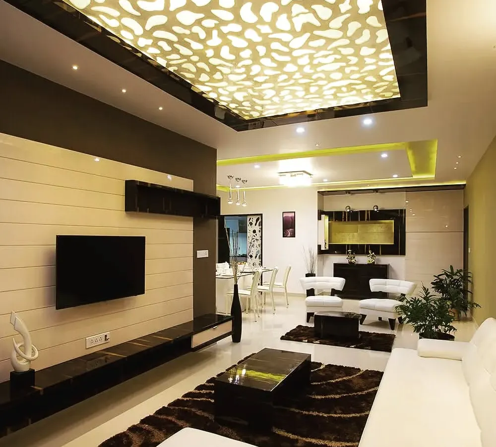 The living room of a completed luxury home, demonstrating how our design concepts translate into reality. We designed and installed the custom backlit ceiling panel and the sleek, wall-mounted media unit to create a sophisticated and welcoming atmosphere.