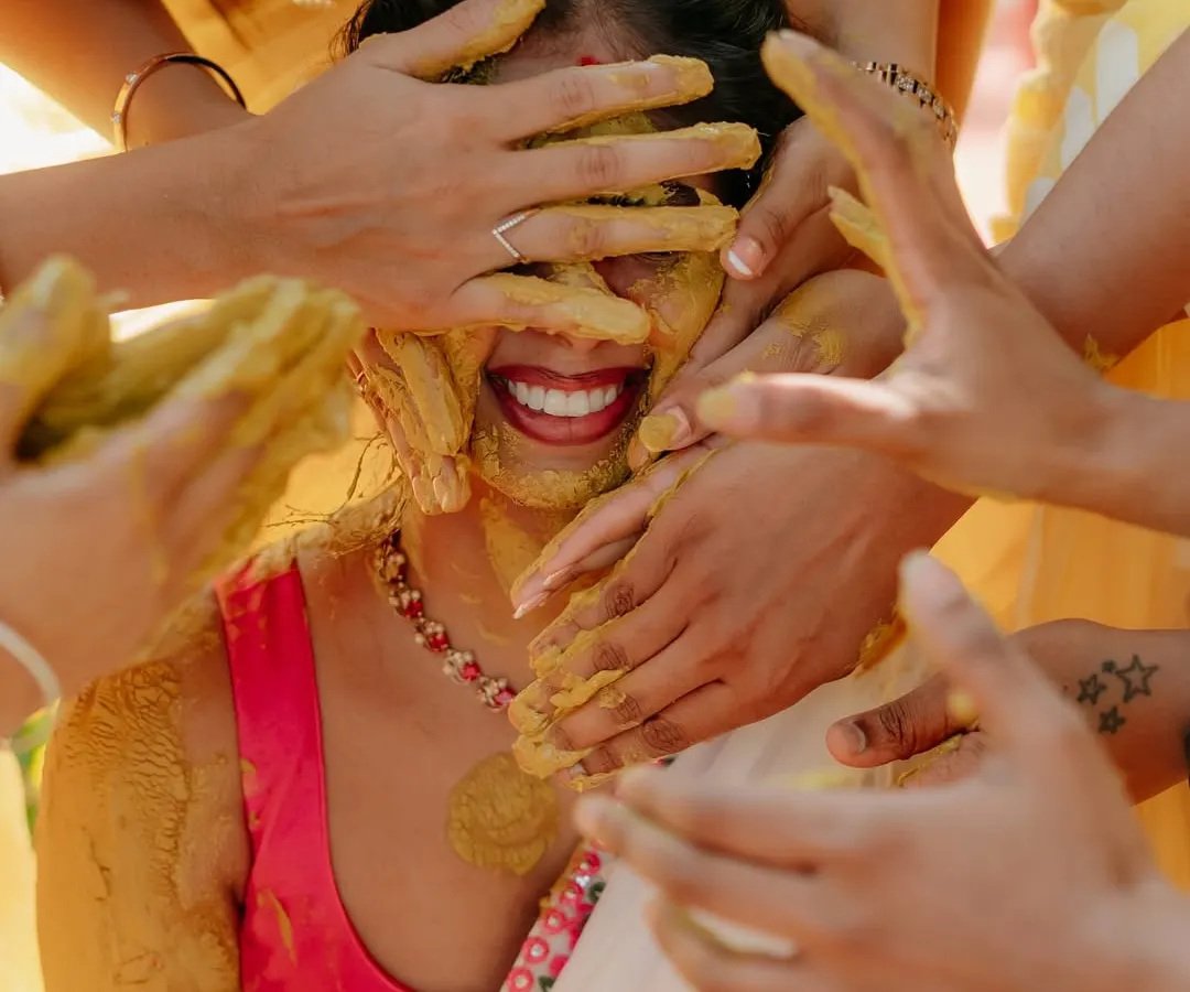 This is the pure, uninhibited joy I strive to capture. A candid moment from a Haldi ceremony, where family and friends shower the bride with love and turmeric. These authentic, emotional shots are the heart of my photography style.