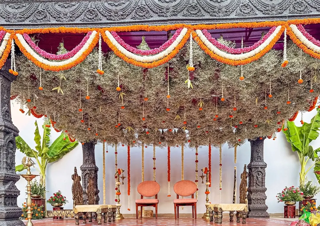 A bride's dream of a temple-style mandap, brought to life with stone-washed textures and a canopy of delicate, hanging florals. This sacred space was designed to feel as if it held generations of blessings.
