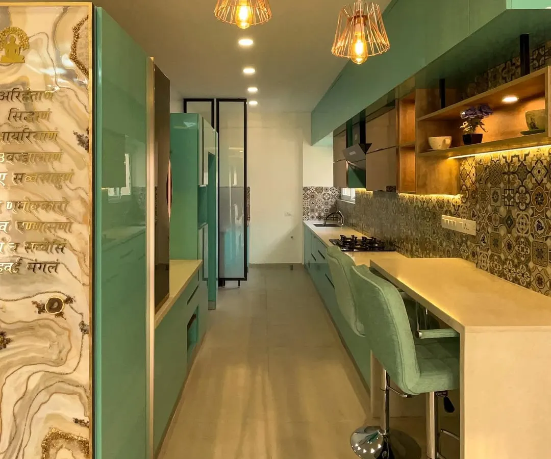 A look at a vibrant and highly functional parallel kitchen. I used a refreshing aqua color for the high gloss cabinets and paired it with patterned backsplash tiles and a cozy breakfast bar, all built with durable Boiling Water Proof ply.