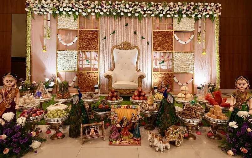 A classic and grand Seemantha decoration, featuring a unique backdrop made of assorted dry fruits. The setup is completed with my signature 21-plate arrangement, thematic dolls, and peacock figures for a rich, traditional feel.
