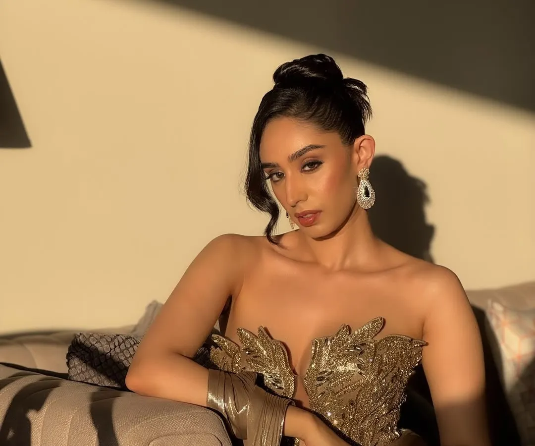 Capturing the magic of golden hour for a cocktail glam look. This full-shot highlights how the makeup, with its warm tones and radiant finish, works with the lighting and the metallic sheen of the gown. It's a sophisticated, editorial style perfect for an elegant evening event.
