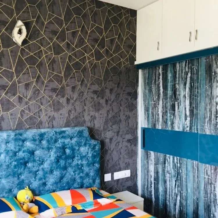 Here is a great example of creating a bold bedroom atmosphere. I applied a dark, geometric-patterned wrap to the accent wall and a contrasting abstract blue design to the sliding wardrobe doors. This shows how we can mix and match from over 10,000 designs to create a truly personal space.