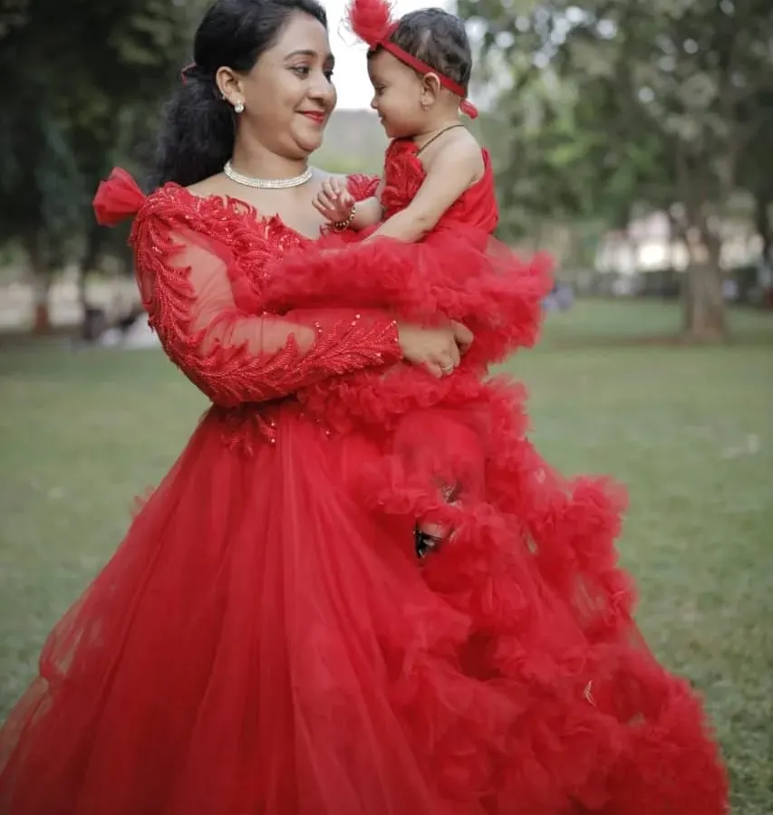 We love creating these special moments. This matching red ruffle gown set for mother and daughter is perfect for birthdays, photoshoots, or any celebration where you want to shine together.