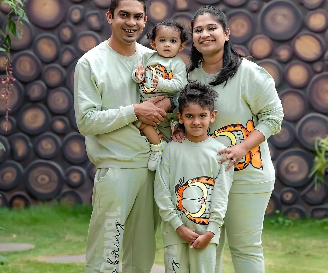 A perfect family day out. We love it when families coordinate their outfits, like these adorable matching sweatshirts. This outdoor portrait captures the happy, united spirit of this family of four.
