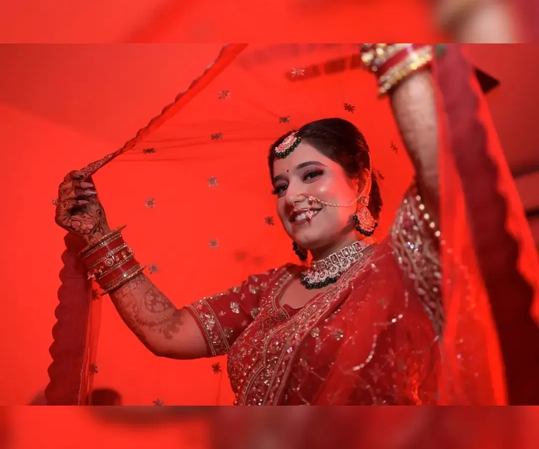 This artistic bridal portrait uses dramatic red lighting to create a striking and memorable image. I focus on capturing the bride's personality, here using the veil to frame her happy expression on her wedding day.