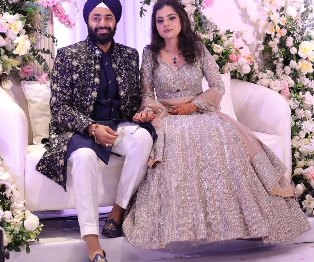 For their sangeet night, this couple wanted pure elegance. I created a custom navy blue bandhgala jacket for him, covered in detailed silver embroidery, to complement her breathtaking silver lehenga. The result is a coordinated look that feels sophisticated, royal, and perfect for a night of celebration.