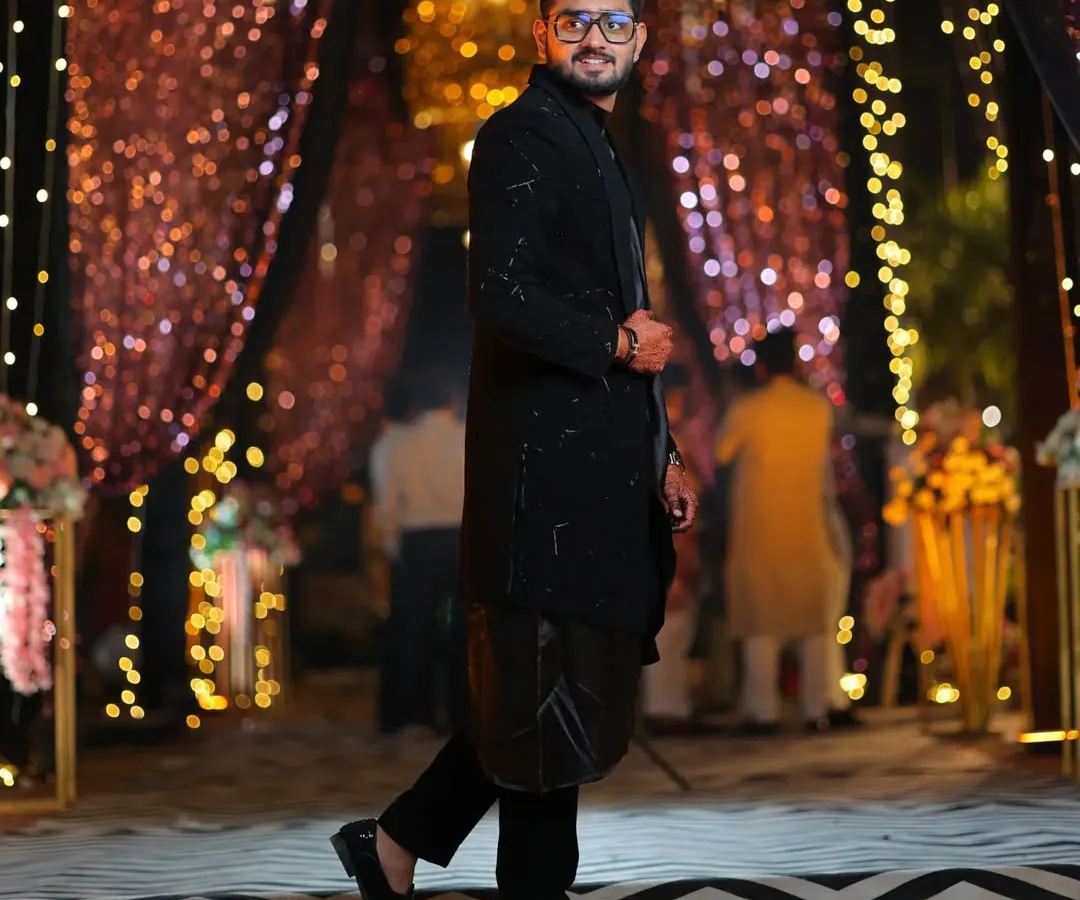 This is my open-style black Indo-western. I used a combination of salli pipe and katdana beadwork for texture, layered over a flowing koul kurta for a modern reception look.
