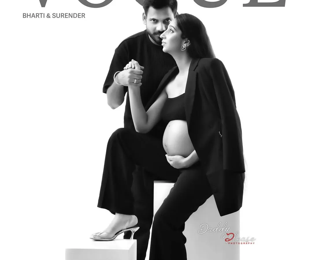 A creative, magazine-style couple's portrait designed to look like a Vogue cover. This black and white shot captures the modern, chic style we can achieve for parents-to-be who want something unique.